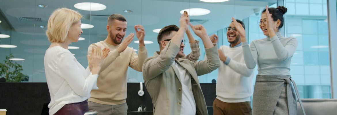 Diverse group of colleagues celebrating success in office